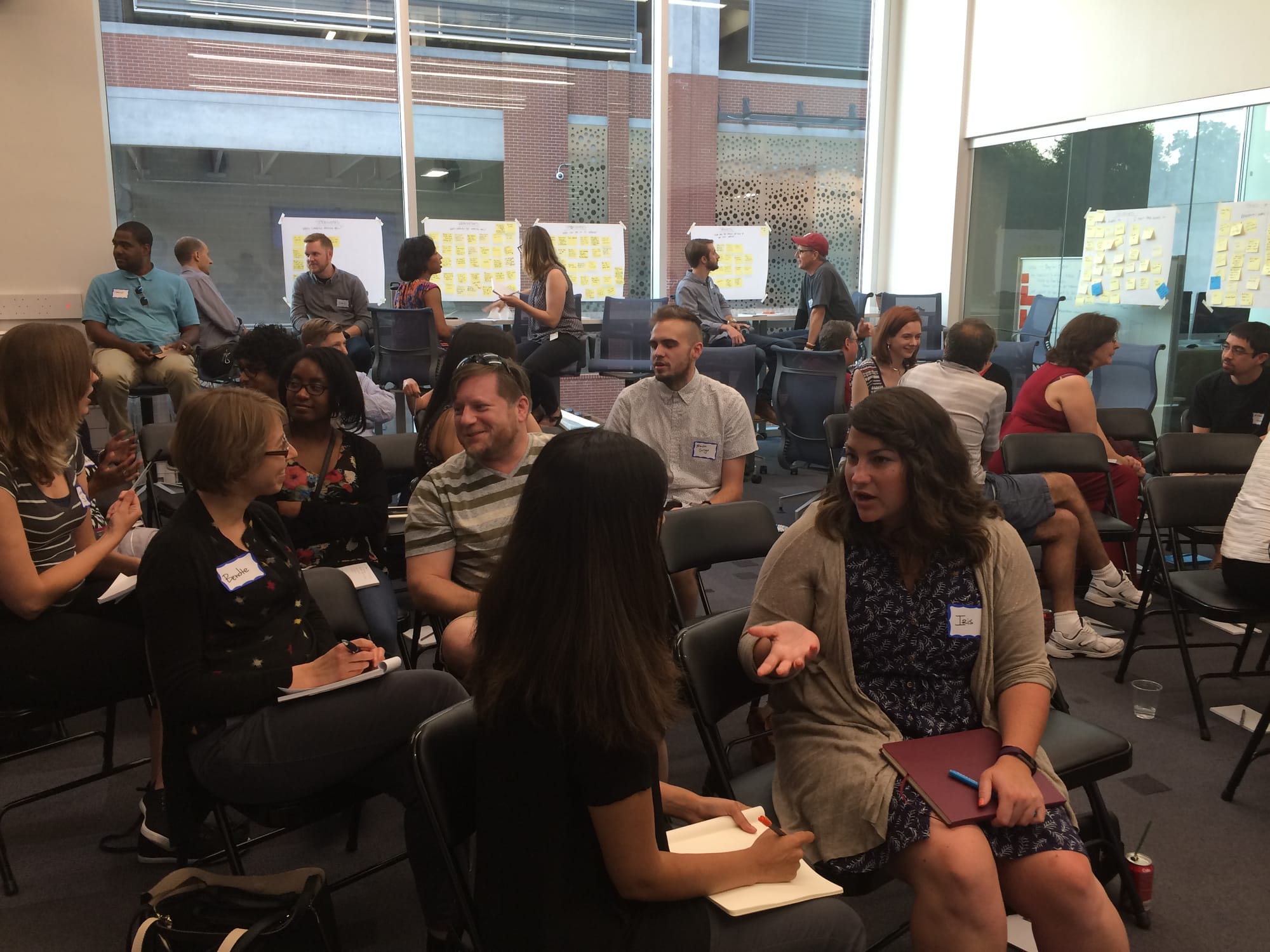 A large group of attendees chatting with each other at an exploreUX event